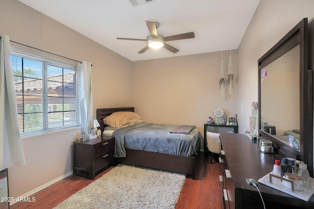 bedroom with dark hardwood / wood-style floors and ceiling fan