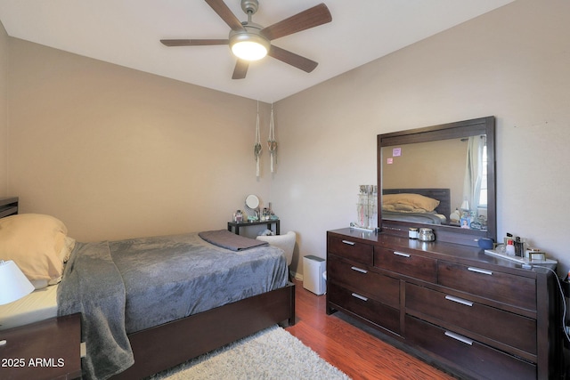 bedroom with ceiling fan and dark hardwood / wood-style flooring