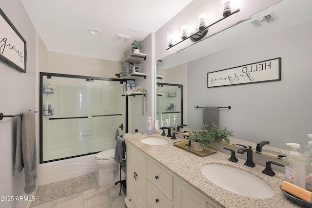 full bathroom featuring toilet, vanity, and bath / shower combo with glass door