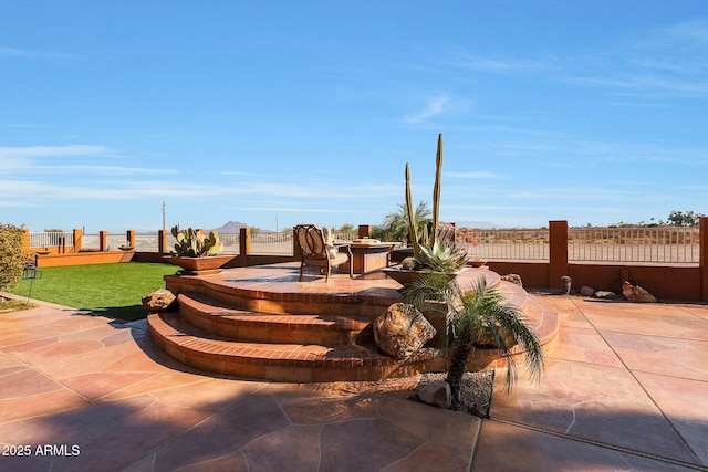 view of patio / terrace featuring an outdoor fire pit