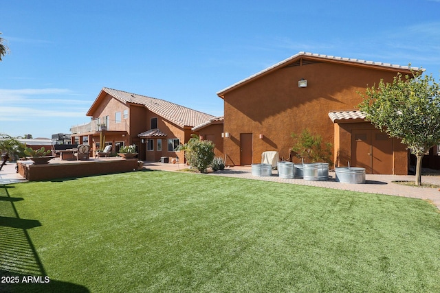 view of yard featuring a balcony and a patio