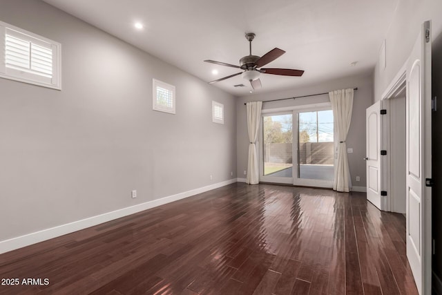 empty room with dark hardwood / wood-style flooring and ceiling fan