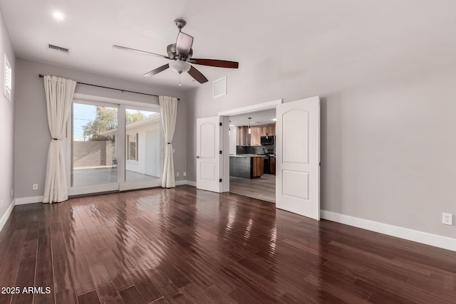 unfurnished living room with dark wood-type flooring and ceiling fan