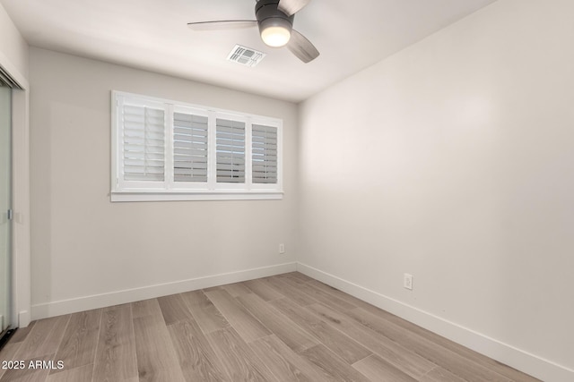 spare room with light hardwood / wood-style flooring and ceiling fan