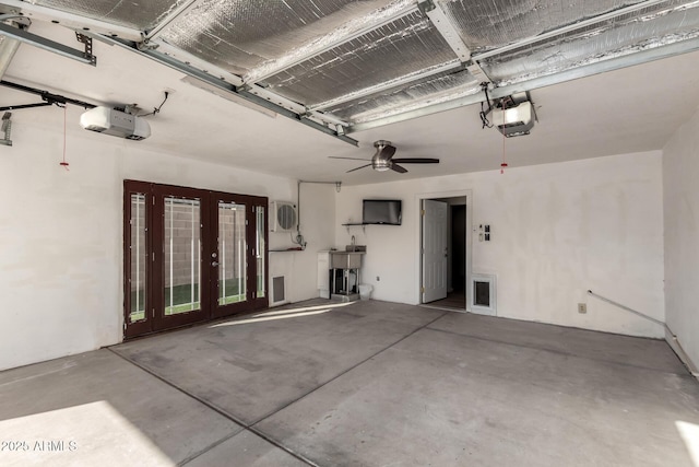 garage featuring a garage door opener, ac unit, and french doors