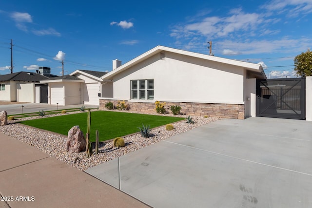 view of front of home with a garage and a front lawn