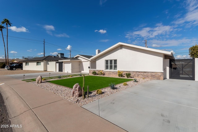 ranch-style home featuring a garage and a front lawn