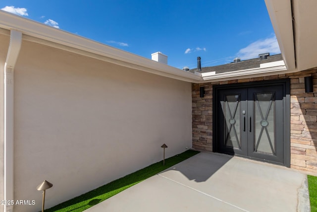 entrance to property featuring french doors