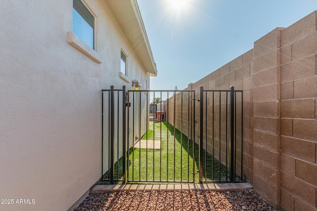 view of gate featuring a lawn