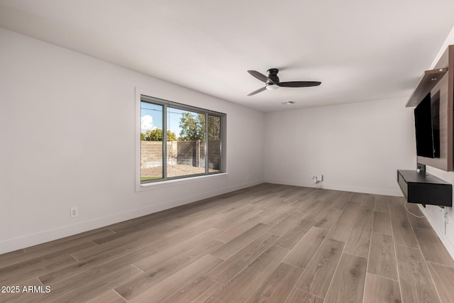 unfurnished living room with ceiling fan and light hardwood / wood-style floors