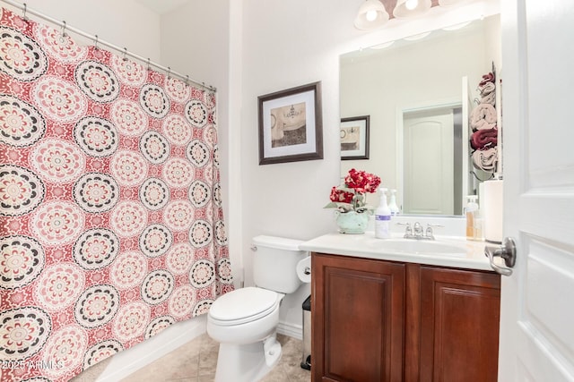 bathroom featuring vanity, tile patterned flooring, and toilet