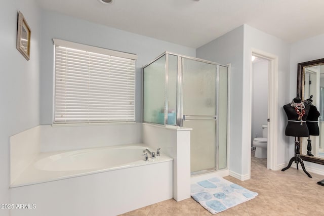 bathroom featuring tile patterned floors, toilet, and separate shower and tub