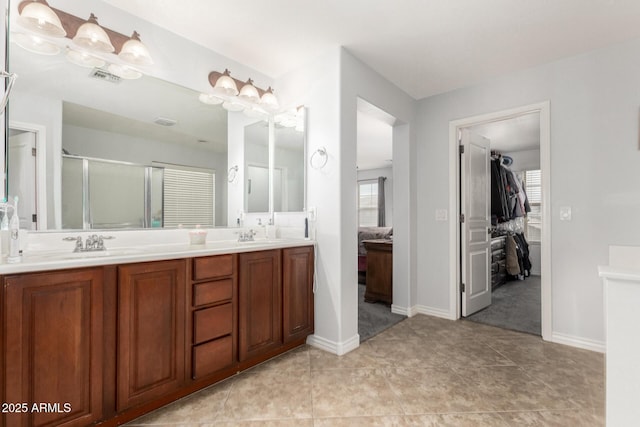 bathroom featuring vanity and a shower with door