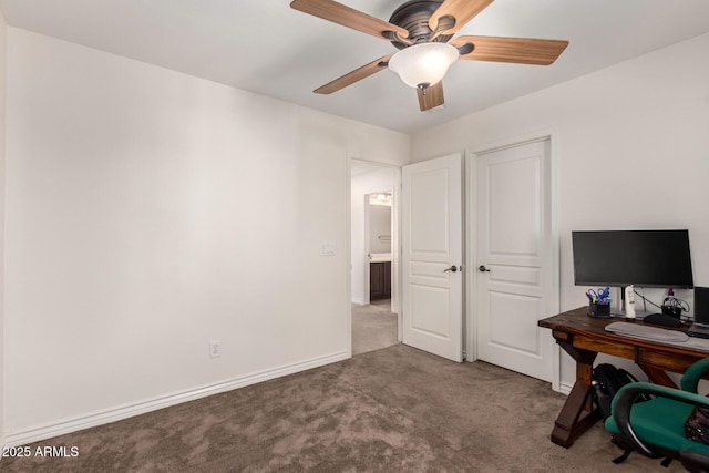 unfurnished office featuring carpet floors and ceiling fan