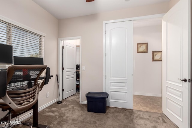 carpeted home office featuring ceiling fan