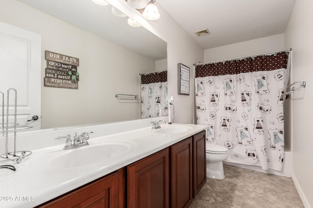 full bathroom featuring tile patterned flooring, vanity, toilet, and shower / bath combo with shower curtain