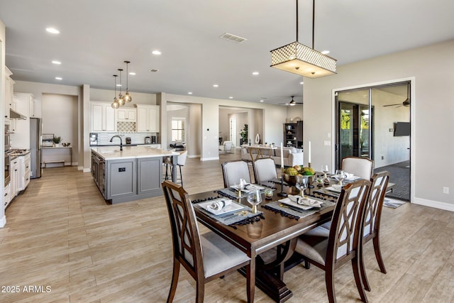 dining space featuring sink and ceiling fan