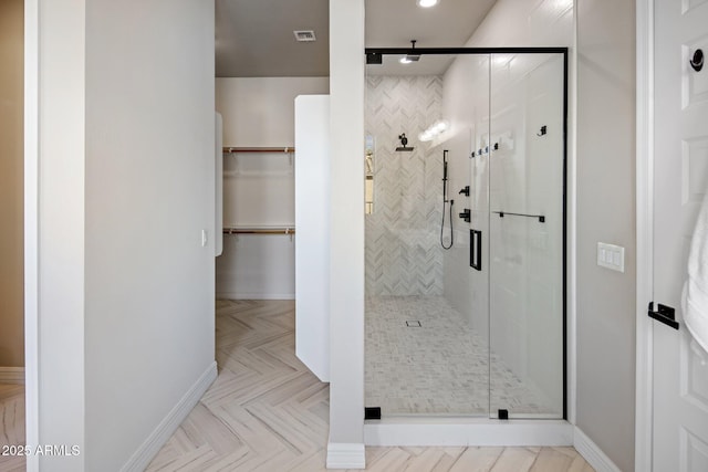 bathroom featuring a shower with shower door