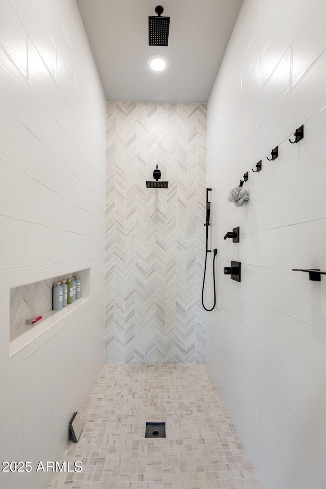 bathroom with a tile shower