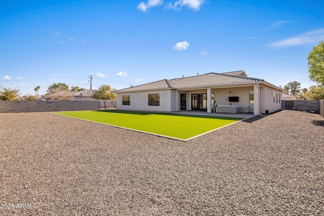 back of property with a patio, outdoor lounge area, and ceiling fan