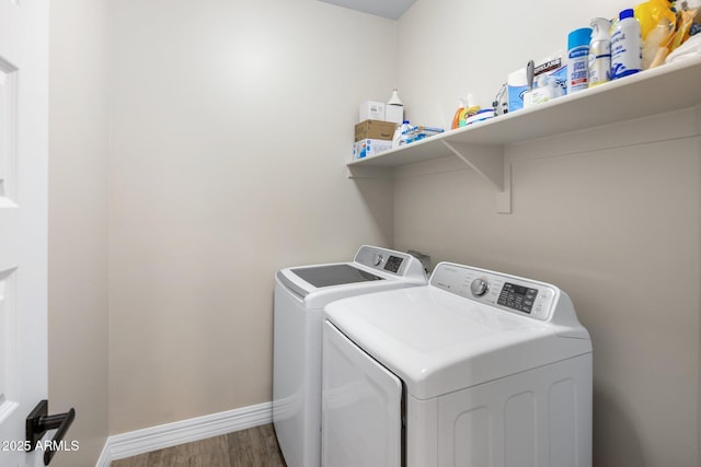 laundry room with wood-type flooring and washer and dryer