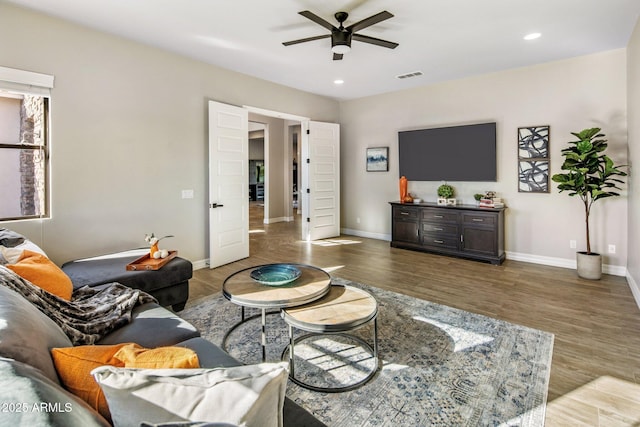 living room with hardwood / wood-style flooring and ceiling fan