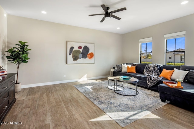 living room with ceiling fan and light hardwood / wood-style floors