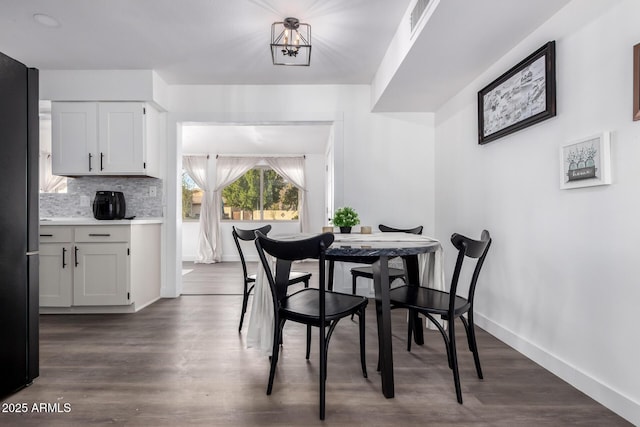 dining area with dark hardwood / wood-style flooring