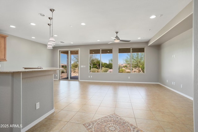 21532 N 262nd Ln, Buckeye, AZ 85396 - unfurnished living room with light tile patterned floors, a ceiling fan, recessed lighting, and baseboards
