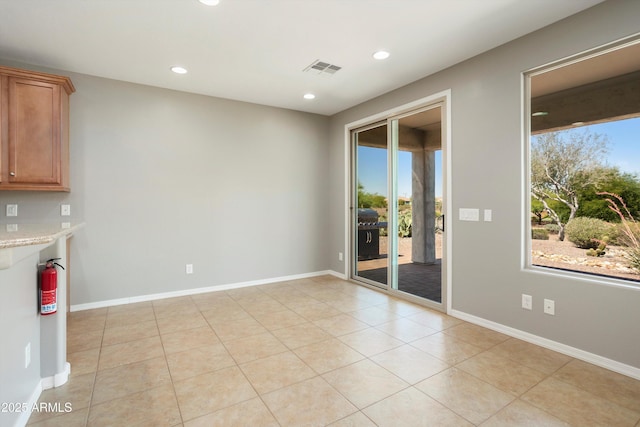 21532 N 262nd Ln, Buckeye, AZ 85396 - spare room featuring plenty of natural light, recessed lighting, light tile patterned floors, and baseboards