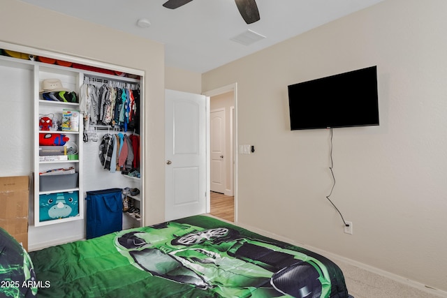 bedroom with ceiling fan, visible vents, baseboards, a closet, and carpet