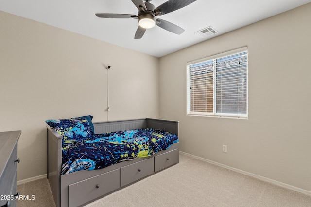 carpeted bedroom featuring a ceiling fan, baseboards, and visible vents
