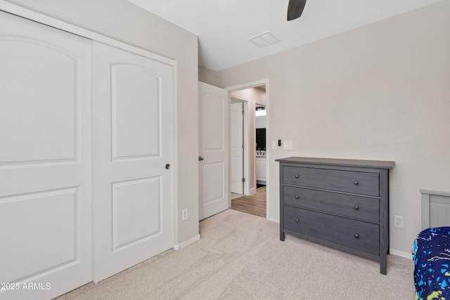 carpeted bedroom featuring baseboards, ceiling fan, and a closet