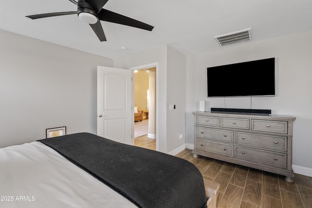 bedroom featuring visible vents, wood tiled floor, baseboards, and a ceiling fan