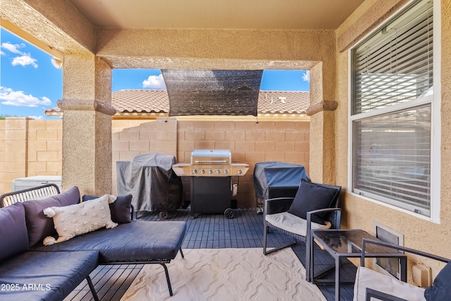 view of patio featuring fence and grilling area