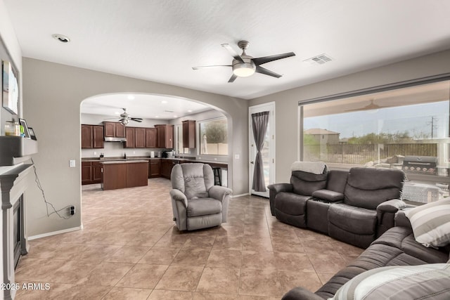 17005 S Coleman St, Phoenix, AZ 85045 - living area featuring arched walkways, baseboards, ceiling fan, and visible vents