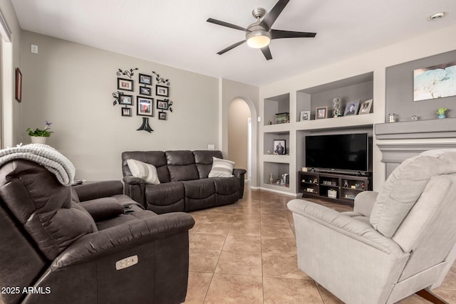 17005 S Coleman St, Phoenix, AZ 85045 - living room with light tile patterned flooring, a ceiling fan, arched walkways, and built in shelves