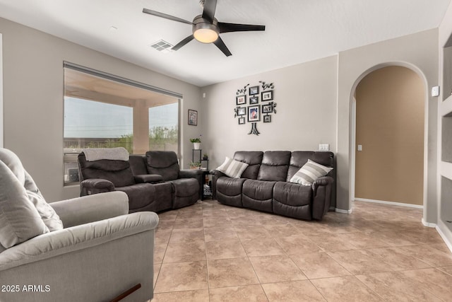 17005 S Coleman St, Phoenix, AZ 85045 - living room with light tile patterned flooring, visible vents, baseboards, ceiling fan, and arched walkways