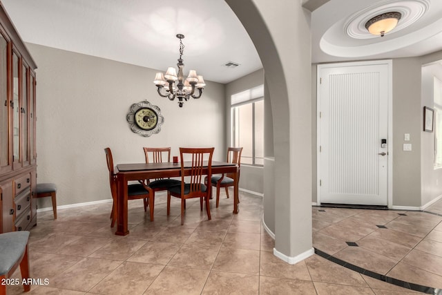 17005 S Coleman St, Phoenix, AZ 85045 - dining room with a notable chandelier, light tile patterned floors, baseboards, visible vents, and arched walkways
