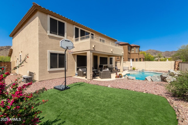 17005 S Coleman St, Phoenix, AZ 85045 - rear view of house featuring a fenced backyard, a balcony, stucco siding, and outdoor lounge area