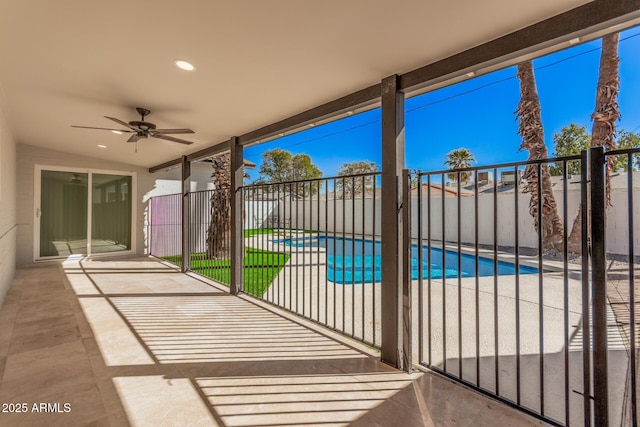 view of patio with a fenced in pool, a ceiling fan, and fence