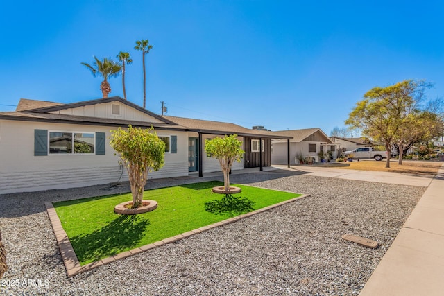 ranch-style house with driveway, an attached garage, and a front yard