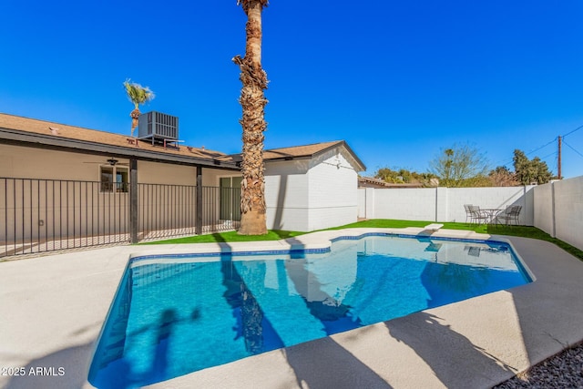 view of swimming pool featuring a fenced in pool, a patio, central AC unit, and a fenced backyard