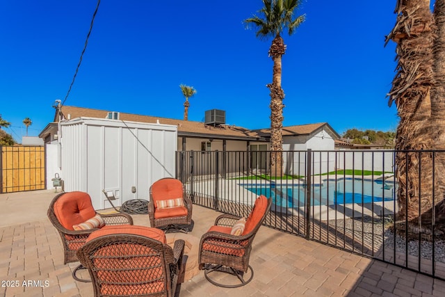 view of patio / terrace with a fenced in pool, central AC, and a fenced backyard