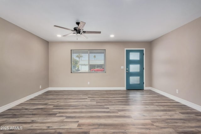 empty room with ceiling fan, baseboards, wood finished floors, and recessed lighting