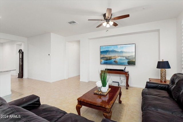 tiled living room with ceiling fan