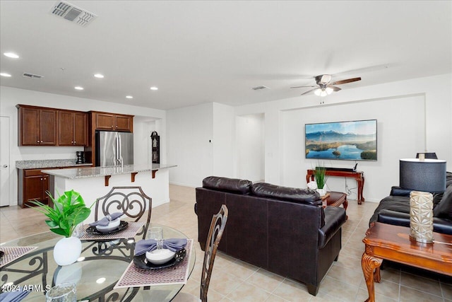 living room featuring ceiling fan and light tile flooring