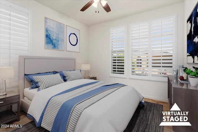 bedroom featuring ceiling fan and dark hardwood / wood-style floors