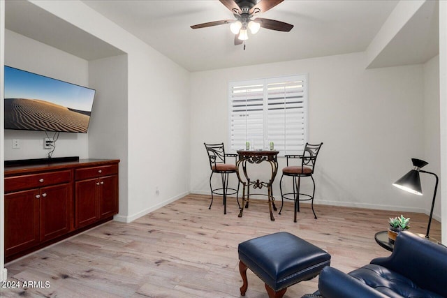 dining space with ceiling fan and light wood-type flooring