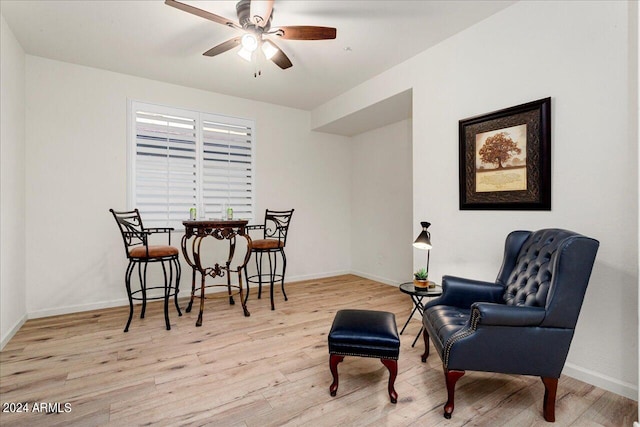 sitting room featuring light hardwood / wood-style floors and ceiling fan